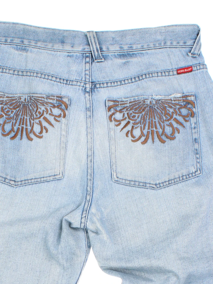 Y2K Guess Jeans in blue colourway with multiple pockets and embroidered branding/detail on the back.