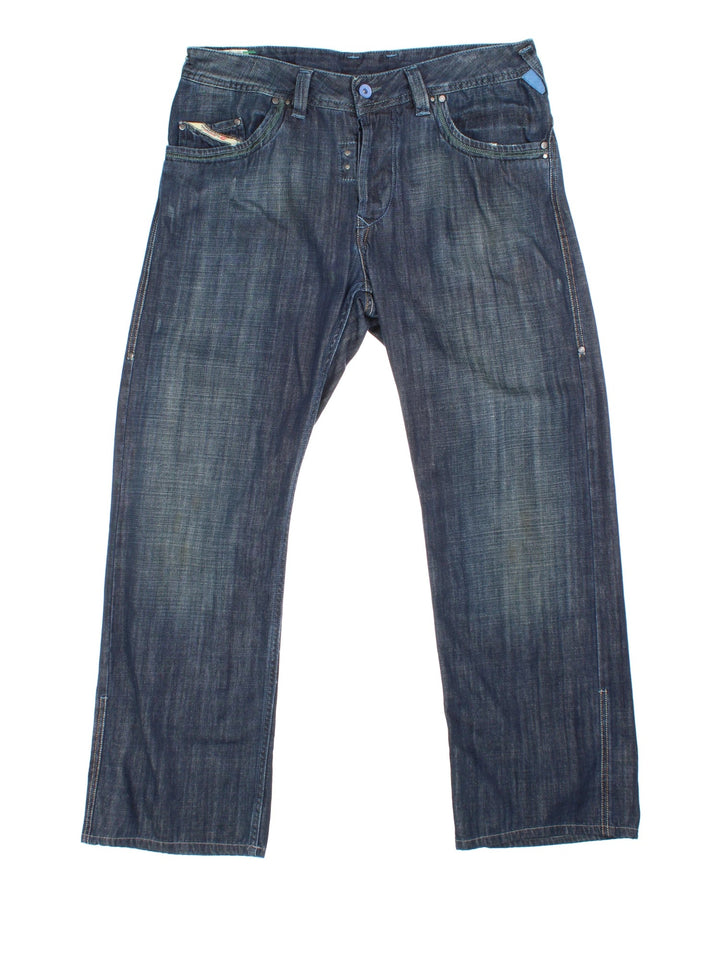 Diesel Jeans in blue colourway with multiple pockets, contrast stitching and embroidered branding on the front/back.