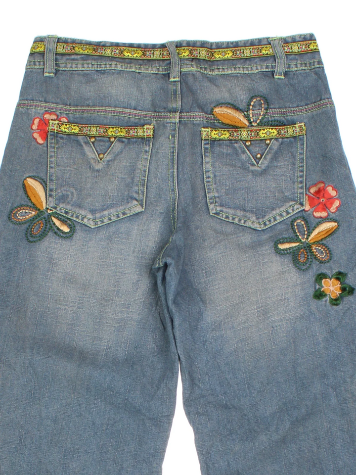 Y2K Embroidered Flared Jeans in blue colourway with multiple pockets and embroidery/rhinestone detailing.
