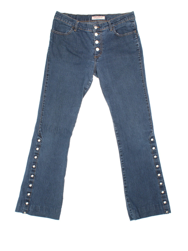 Y2K Miss Sixty Flared Popper Jeans in blue colourway with multiple pockets, popper buttons on the side of the legs, and the logo embroidered on the back.