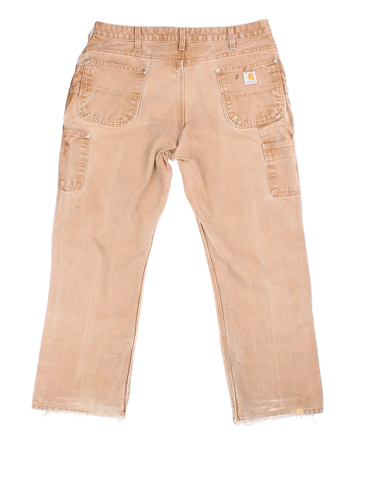 Carhartt Double Knee Jeans in tan colourway with multiple pockets and the logo embroidered on the back.