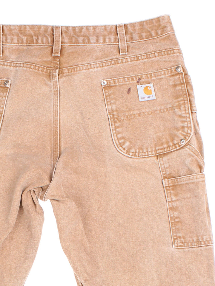 Carhartt Double Knee Jeans in tan colourway with multiple pockets and the logo embroidered on the back.