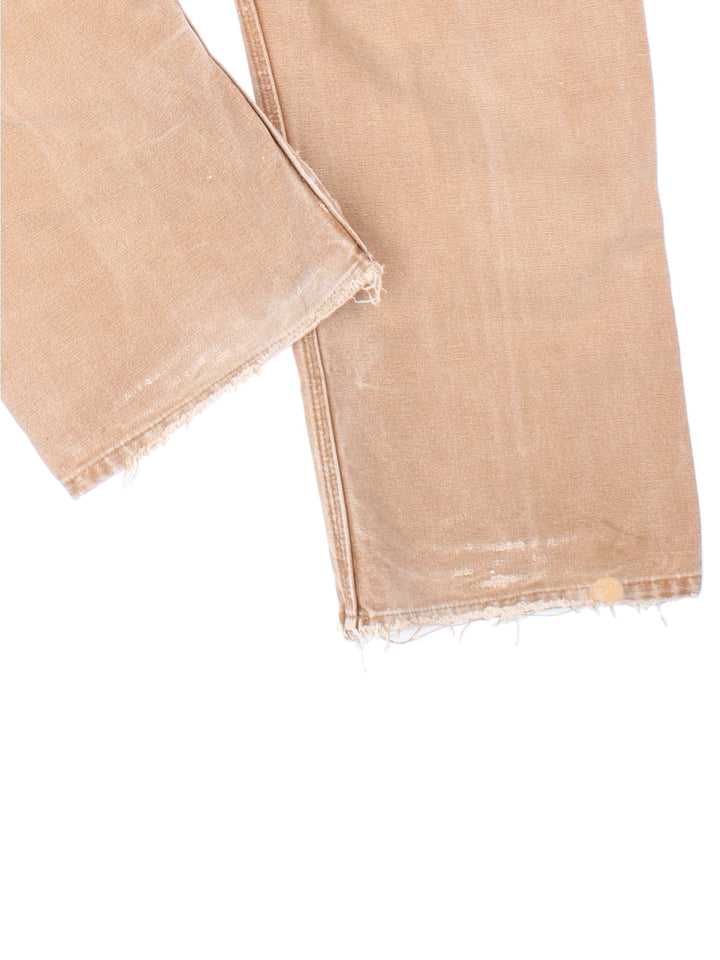 Carhartt Double Knee Jeans in tan colourway with multiple pockets and the logo embroidered on the back.