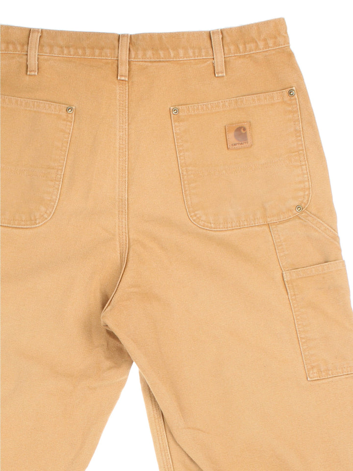 Carhartt Double Knee Jeans in tan colourway with multiple pockets and the logo embroidered on the back.