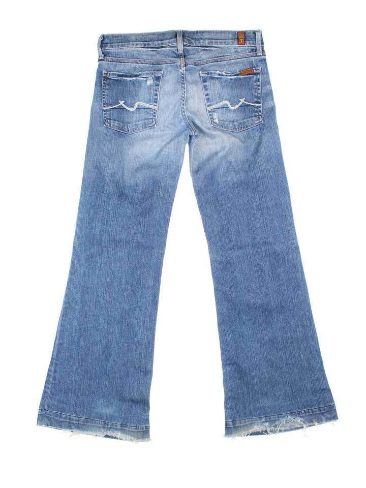 Y2K 7 For All Mankind Low Rise Flared Jeans in blue colourway with multiple pockets and the logo embroidered on the back.