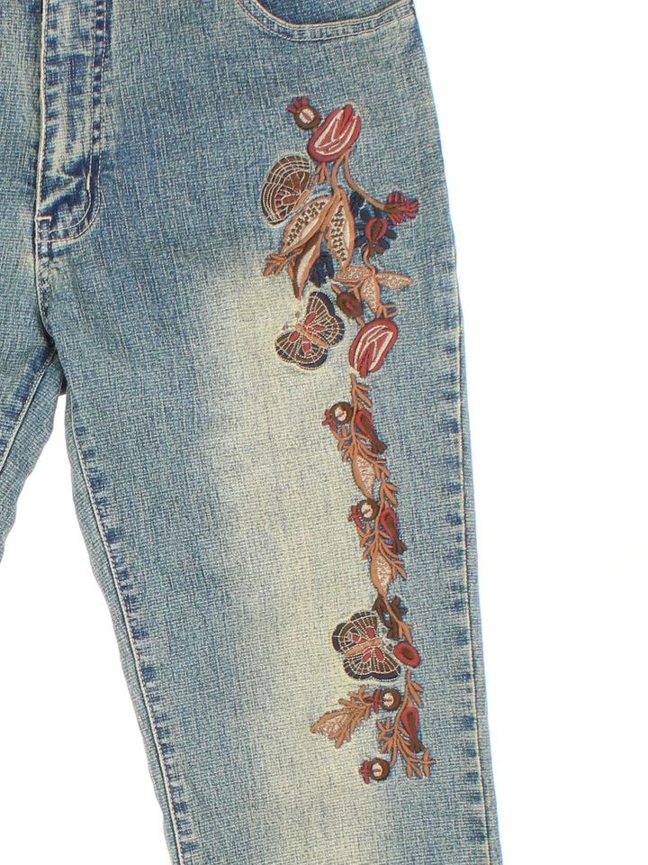 Y2K Embroidered Low Rise Flared Jeans in blue colourway with multiple pockets and embroidered detailing on the front/back.