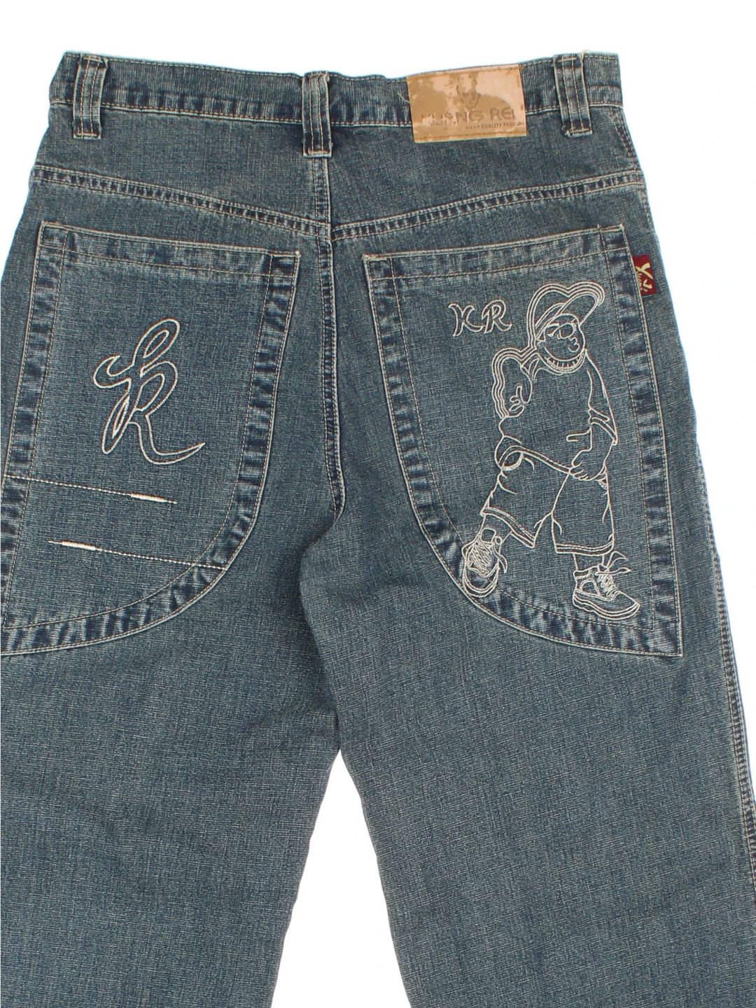 Y2K Baggy Skate Jeans in blue colourway with multiple pockets and embroidered detailing on back.