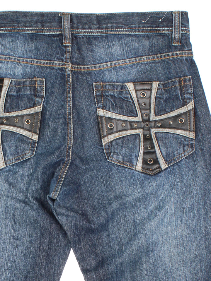 Vintage Y2K Avirex Jeans in blue colourway with multiple pockets and leather detailing on the back.
