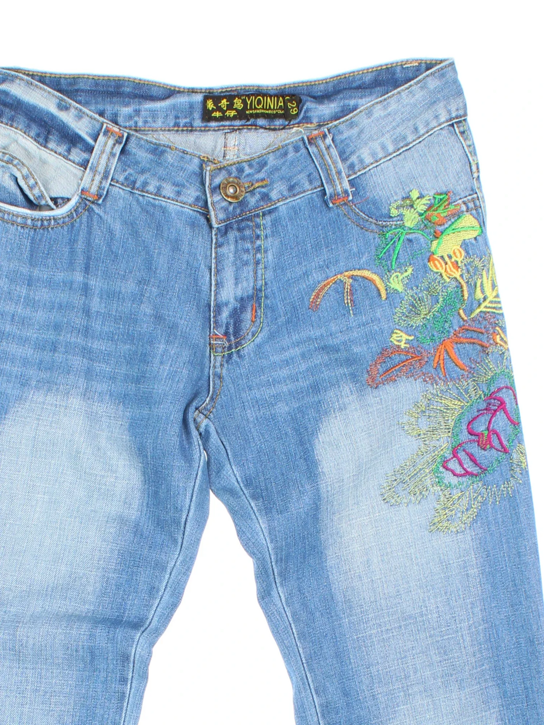 Y2K Embroidered Flared Jeans in blue colourway with multiple pockets, contrast stitching and floral detailing on the front.