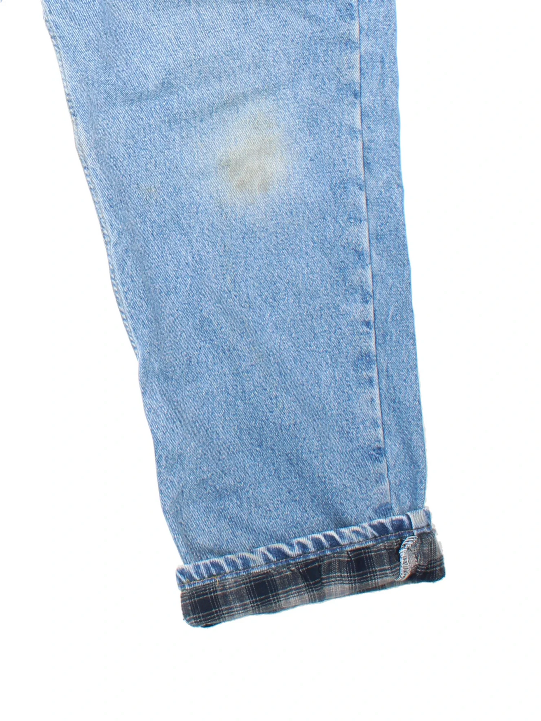 Carhartt Jeans in blue colourway with multiple pockets, plaid pattern lining, and the logo embroidered on the back.