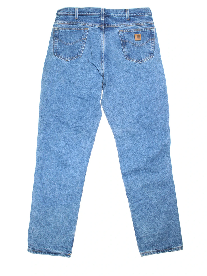 Carhartt Jeans in blue colourway with multiple pockets, plaid pattern lining, and the logo embroidered on the back.
