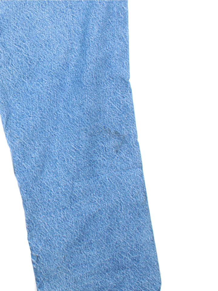 Carhartt Jeans in blue colourway with multiple pockets, plaid pattern lining, and the logo embroidered on the back.