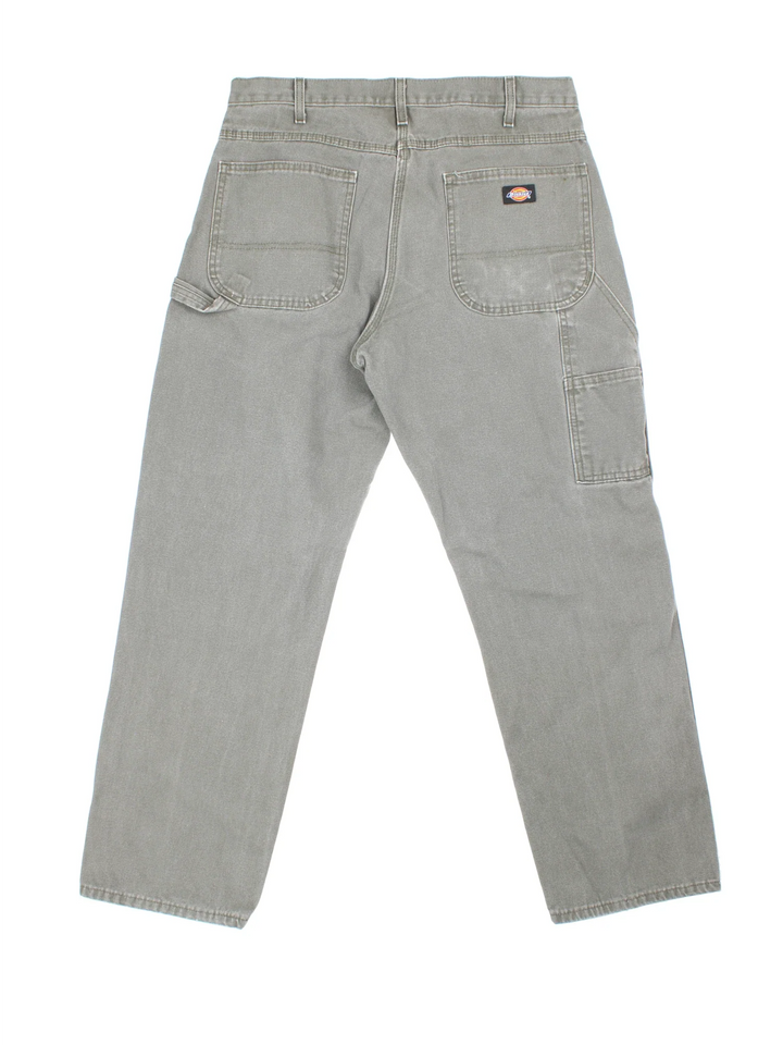 Dickies Carpenter Jeans in a green colourway with multiple pockets and the logo embroidered on the back.