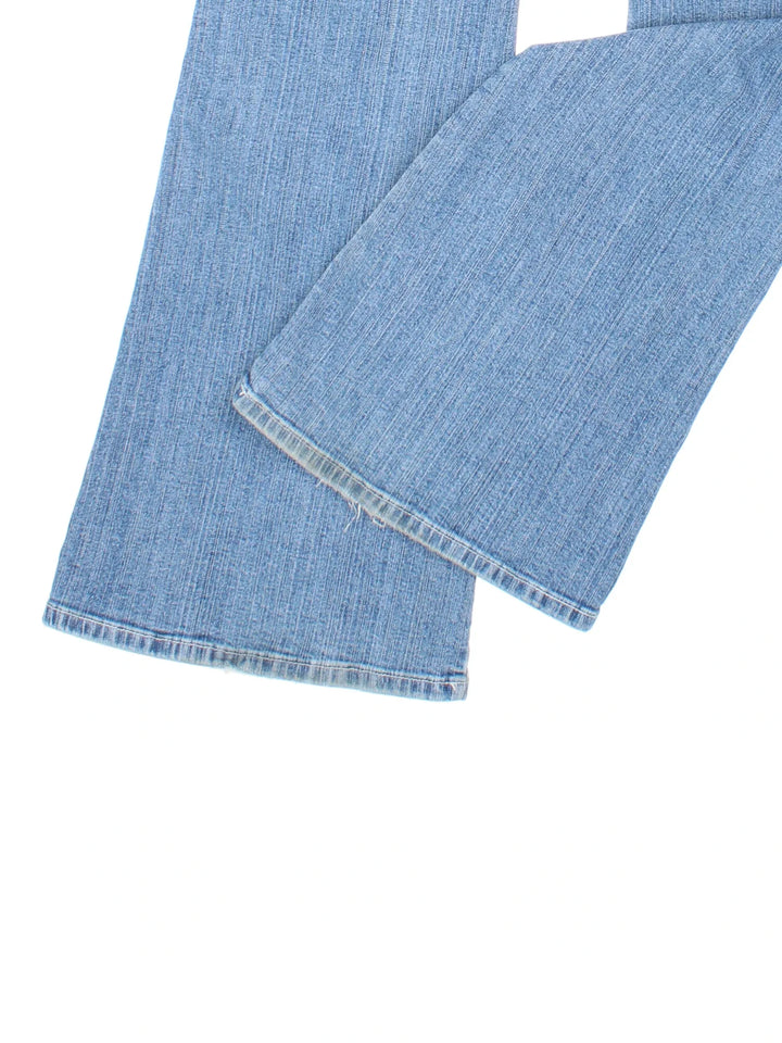 Y2K Punky Fish Flared Jeans in blue colourway with multiple pockets, buckle detail and branding on the front/back.