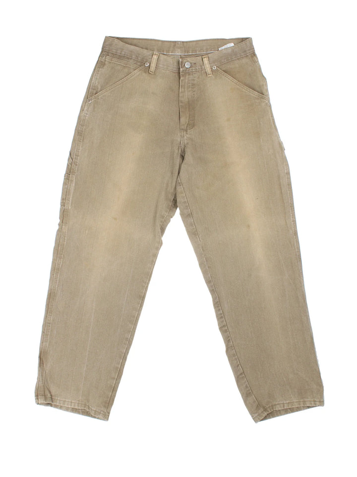 Wrangler Carpenter Jeans in brown colourway with multiple pockets and the logo embroidered on the back.