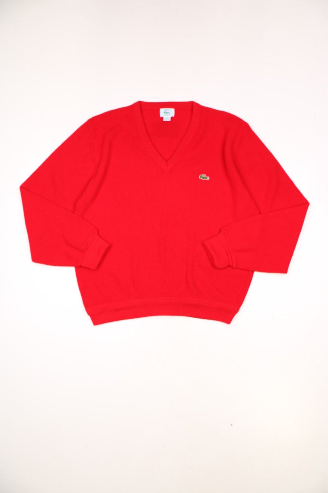 Vintage 70s Lacoste Izod knitted jumper in red. Features signature embroidered logo on the chest.