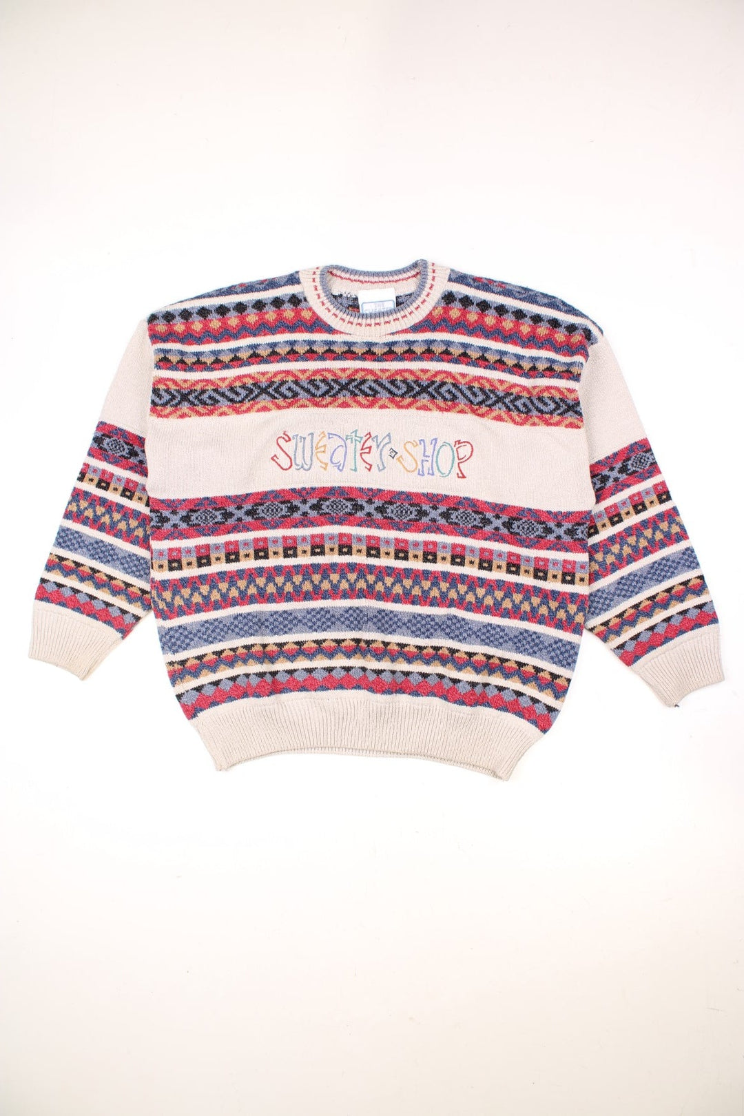 The Sweater Shop Patterned Jumper in a tanned colourway with multicoloured stripes all over, also has the spell out logo embroidered on the front. 