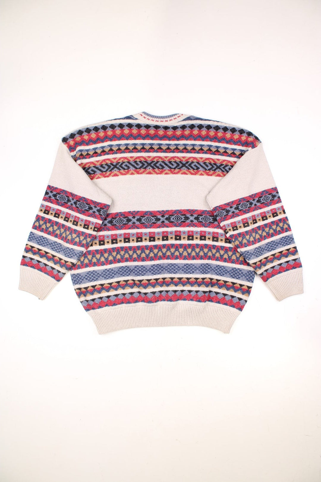 The Sweater Shop Patterned Jumper in a tanned colourway with multicoloured stripes all over, also has the spell out logo embroidered on the front. 