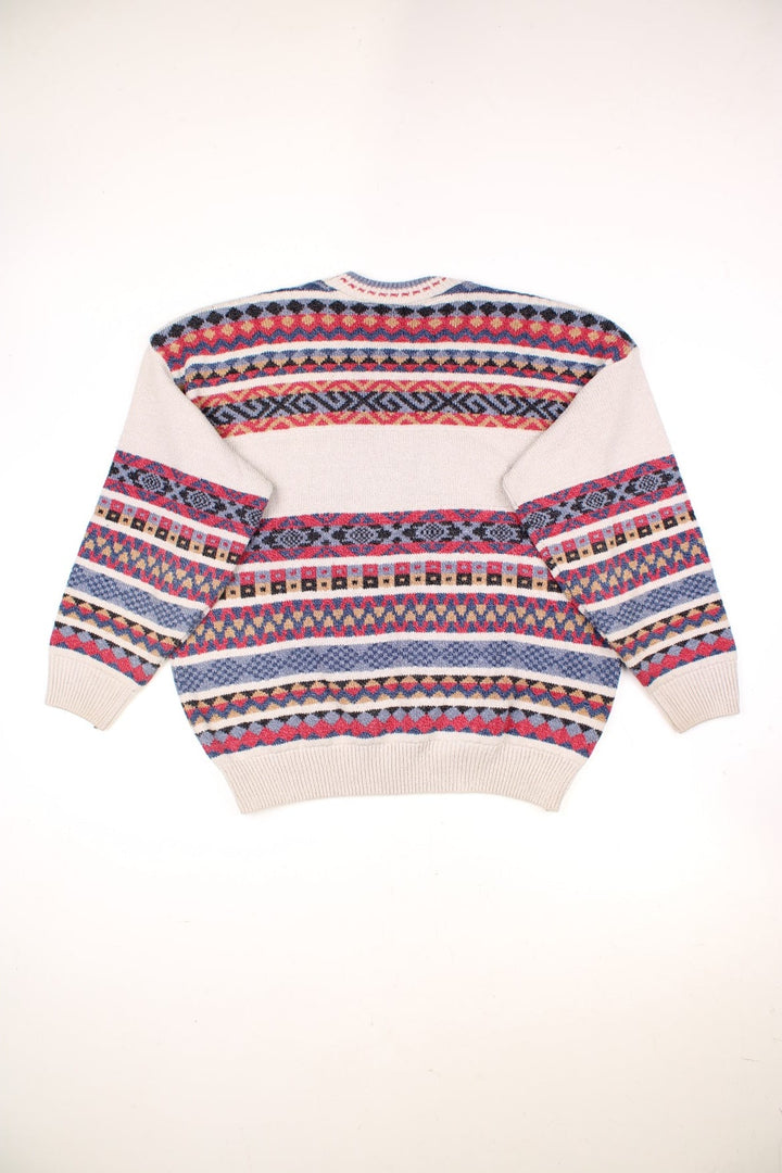The Sweater Shop Patterned Jumper in a tanned colourway with multicoloured stripes all over, also has the spell out logo embroidered on the front. 