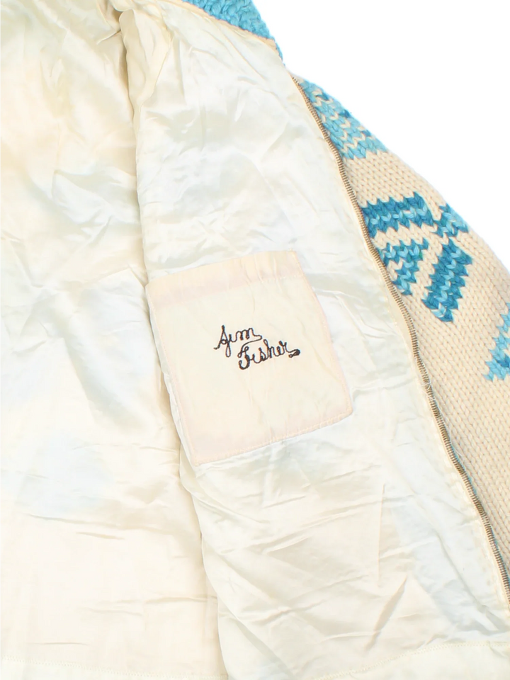Vintage 80's Snowflake Cowichan Knitted Sweater in a tan and blue colourway with snowflake patterns all over, zip up closure and has double front pockets.