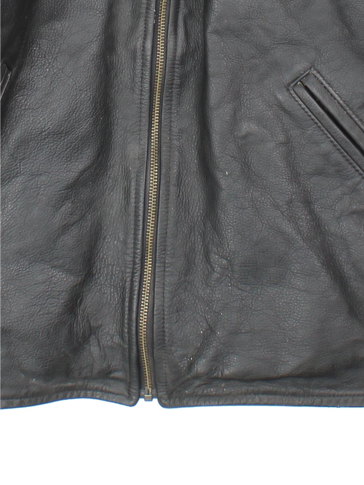 Vintage 1994 Disney Lion King Promo Leather Jacket in black. The jacket has a dagger collar, Lion King logo embroidered on the front panel and an interior pocket. The jacket is also lined with a quilted satin fabric. 