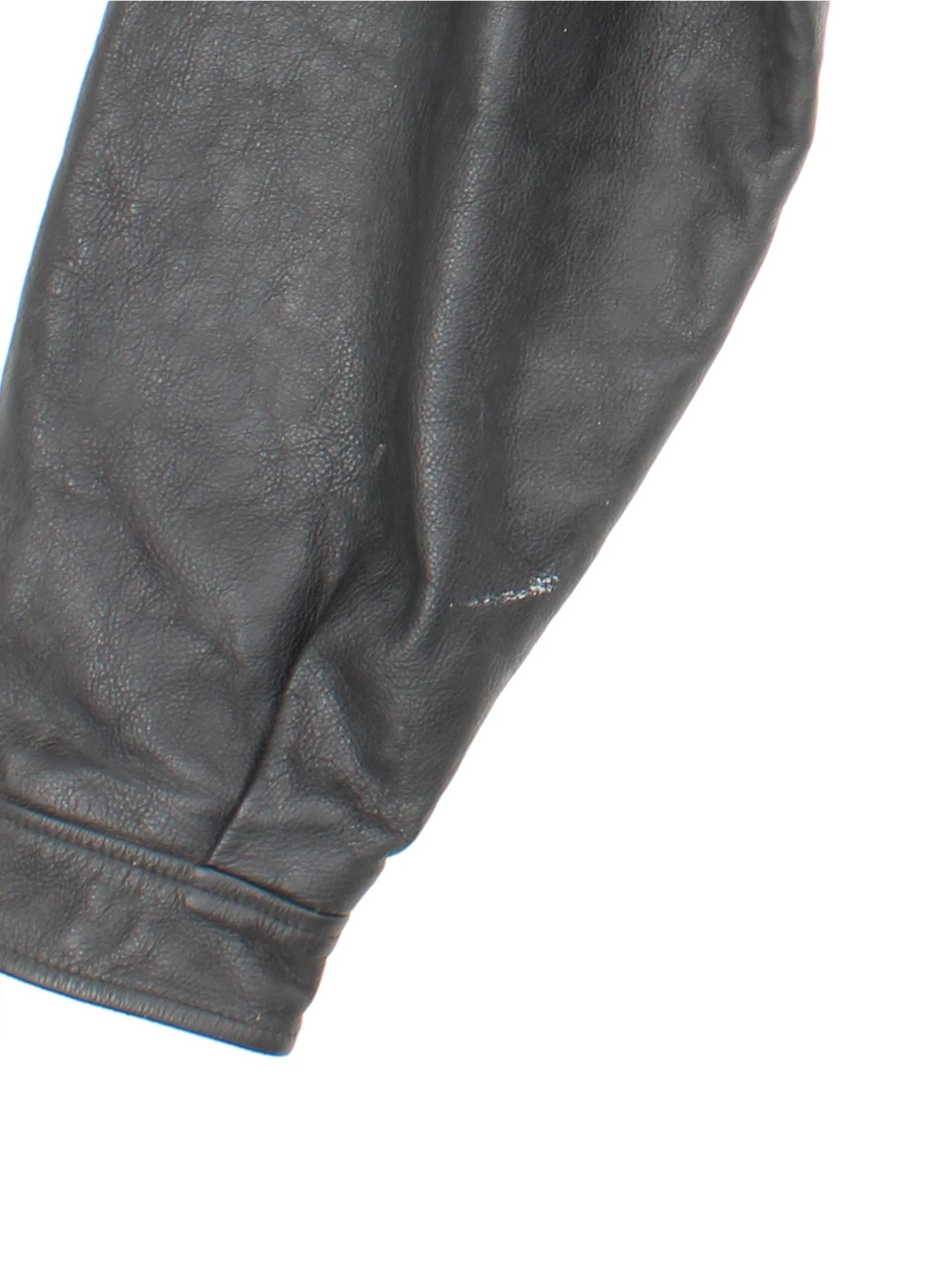 Vintage 1994 Disney Lion King Promo Leather Jacket in black. The jacket has a dagger collar, Lion King logo embroidered on the front panel and an interior pocket. The jacket is also lined with a quilted satin fabric. 