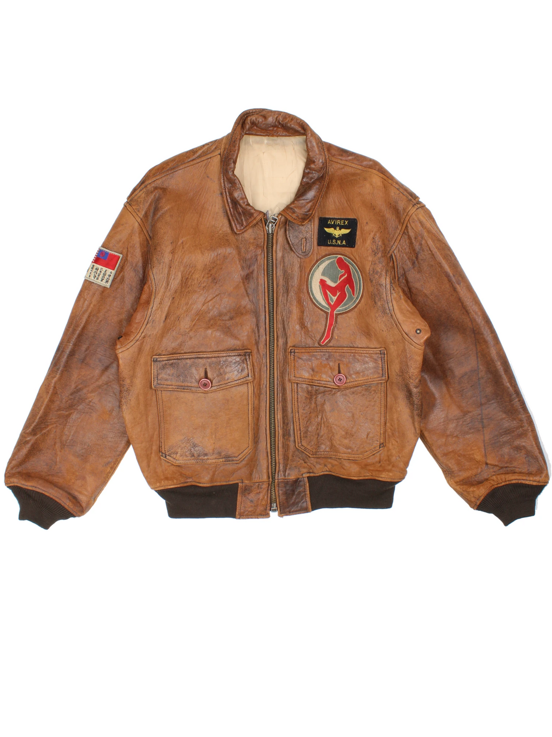 Vintage Avirex Flight Aviator Bomber Jacket in a brown colourway, zip up with side pockets and has badges embroidered on the front alongside the Avirex logo. 