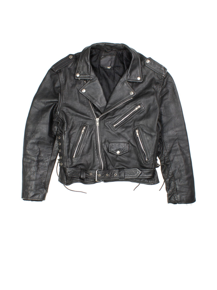 Vintage Leather Biker Jacket in a black colourway. Zip up with multiple pockets, classic biker detailing, buckle and lace detailing at the hem and side.