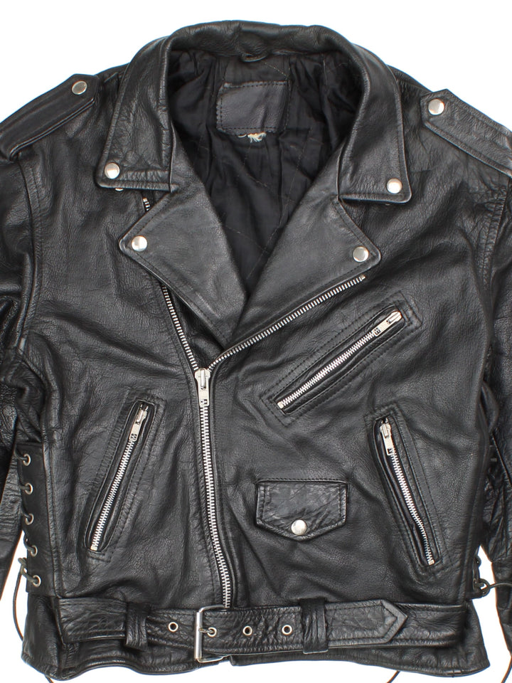 Vintage Leather Biker Jacket in a black colourway. Zip up with multiple pockets, classic biker detailing, buckle and lace detailing at the hem and side.