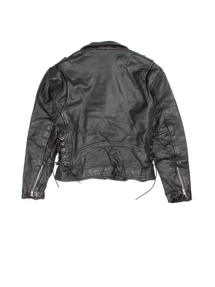 Vintage Leather Biker Jacket in a black colourway. Zip up with multiple pockets, classic biker detailing, buckle and lace detailing at the hem and side.