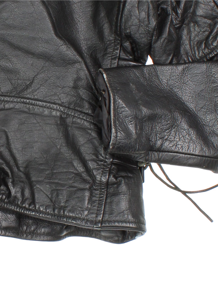 Vintage Leather Biker Jacket in a black colourway. Zip up with multiple pockets, classic biker detailing, buckle and lace detailing at the hem and side.