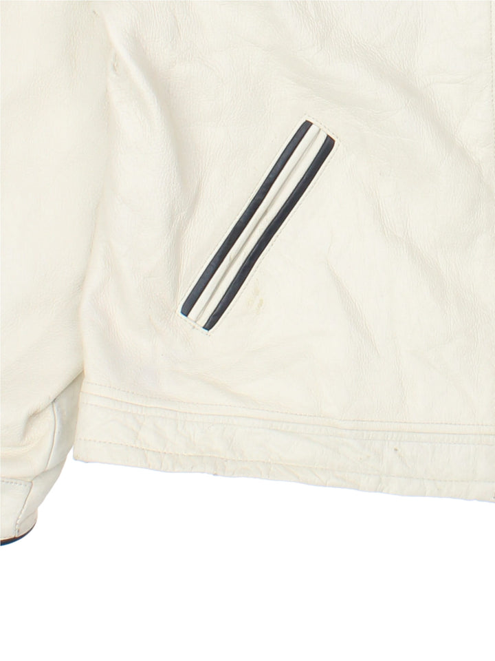 Vintage Guess 1981 Leather Jacket in a tan colourway. Full zip up with double pocket on the front. Varsity style lettering on the front and graphic on the back.