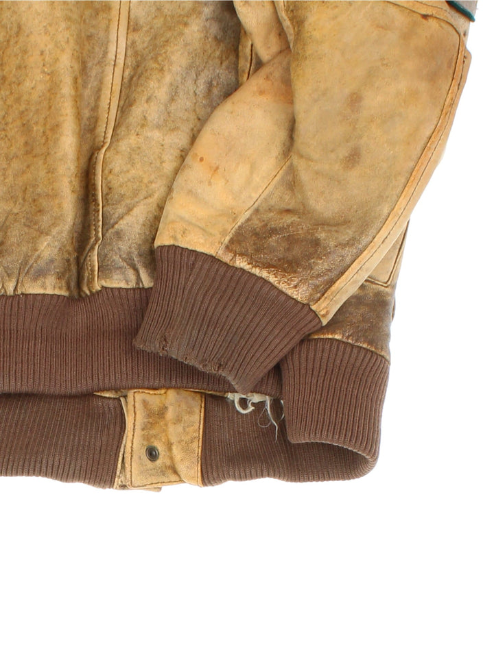 Vintage 90's Aviator Flight Leather Jacket in a brown colourway. Full zip up with double pocket on the front, Brown cuffed hem and classic aviator patches on the front and sleeves.