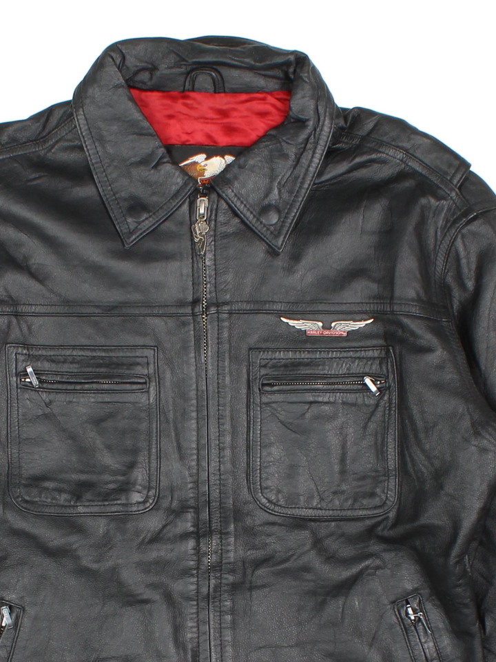 Harley-Davidson Leather Biker Jacket in a black colourway. Zips up and has multiple pockets and the logo tab embroidered on the chest.