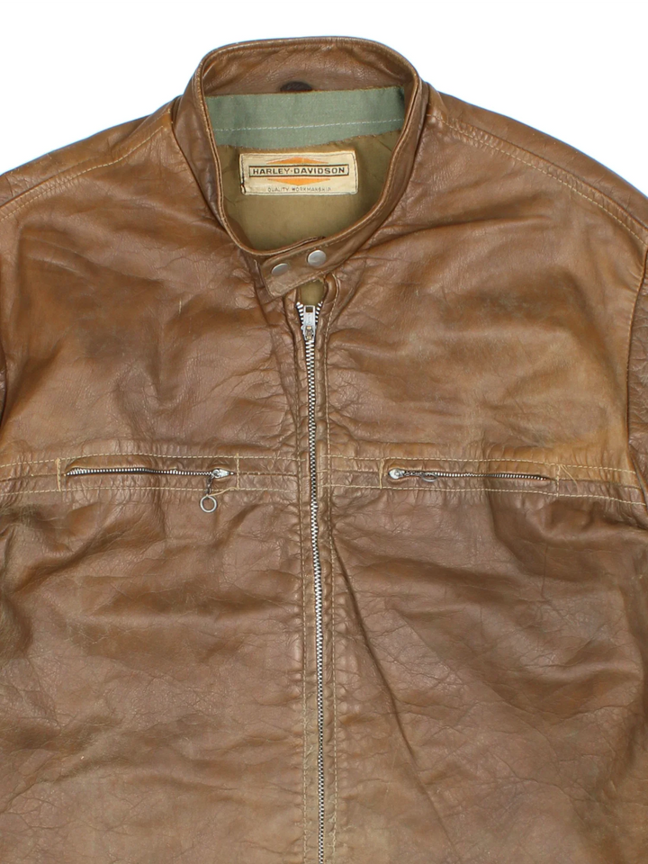60's Harley-Davidson Leather Jacket in a brown colourway. Zips up and has double chest pockets.
