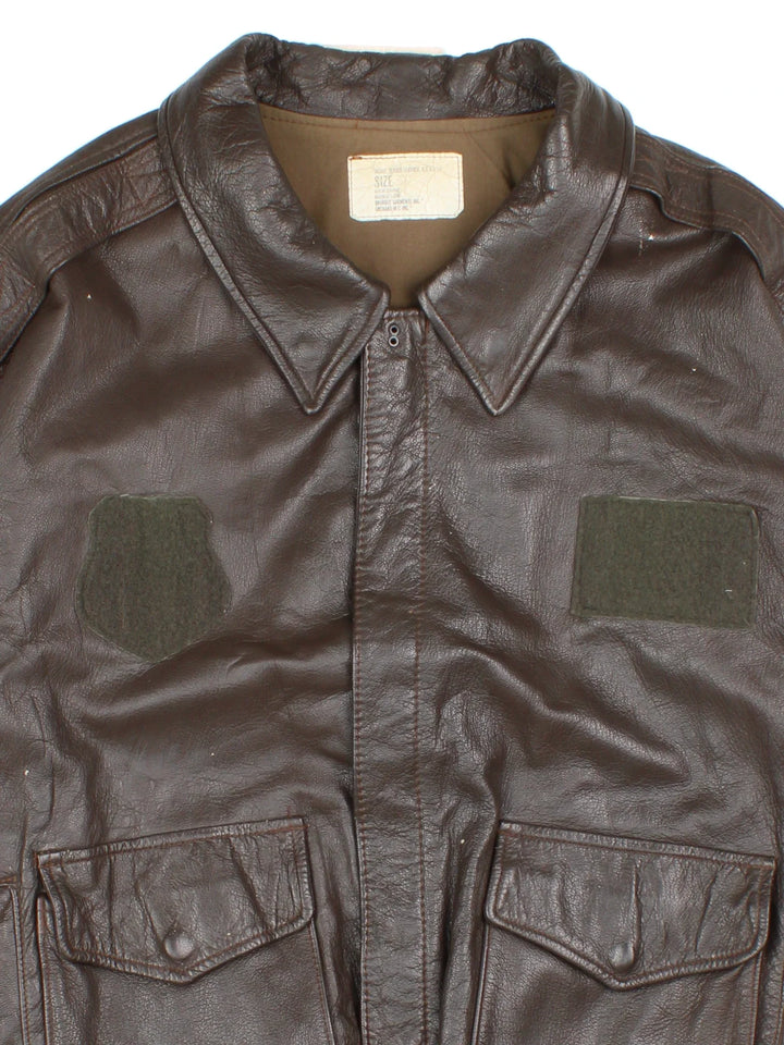 Vintage A-2 Leather Flight Jacket in a brown colourway. Zips up and has multiple pockets, and velcro patches from where badges once were.