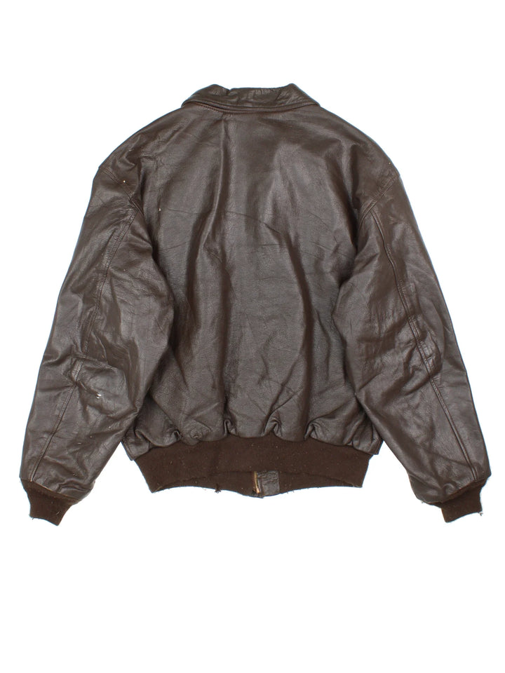 Vintage A-2 Leather Flight Jacket in a brown colourway. Zips up and has multiple pockets, and velcro patches from where badges once were.
