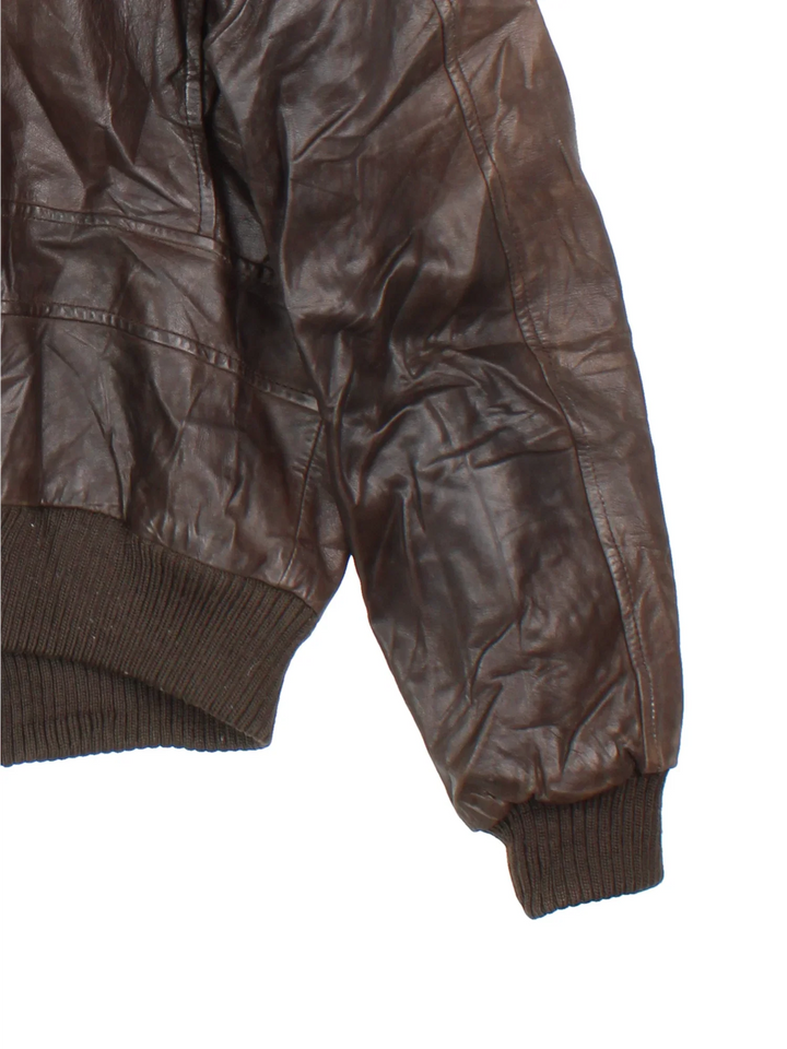 Vintage Leather Flight Jacket in a brown colourway. Zips up and has multiple pockets, and detachable fur collar trim.