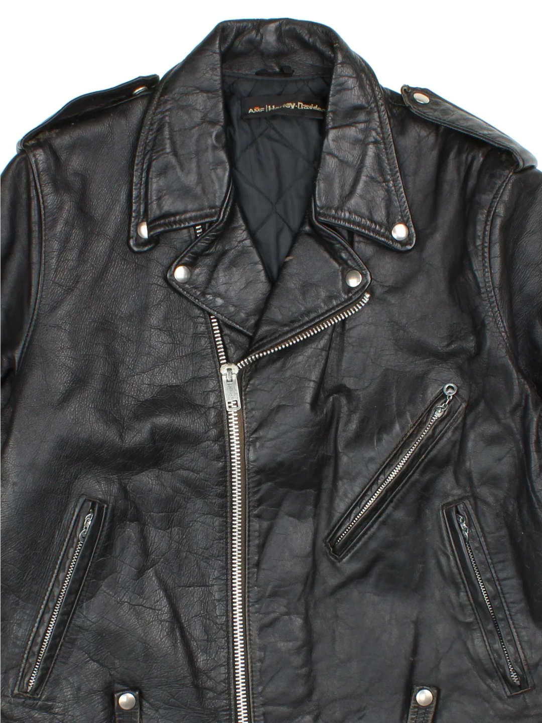 Vintage Harley-Davidson Motorcycle Jacket in a black colourway. Zips up and has multiple pockets, insulated with a quilted lining, and classic motorcycle detailing.