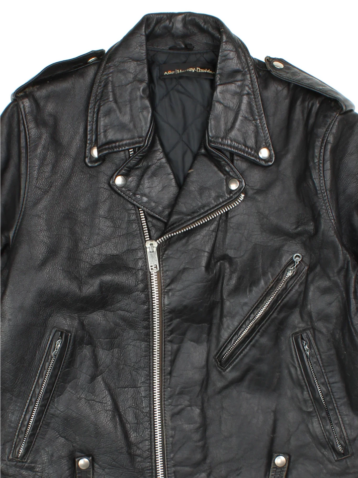 Vintage Harley-Davidson Motorcycle Jacket in a black colourway. Zips up and has multiple pockets, insulated with a quilted lining, and classic motorcycle detailing.