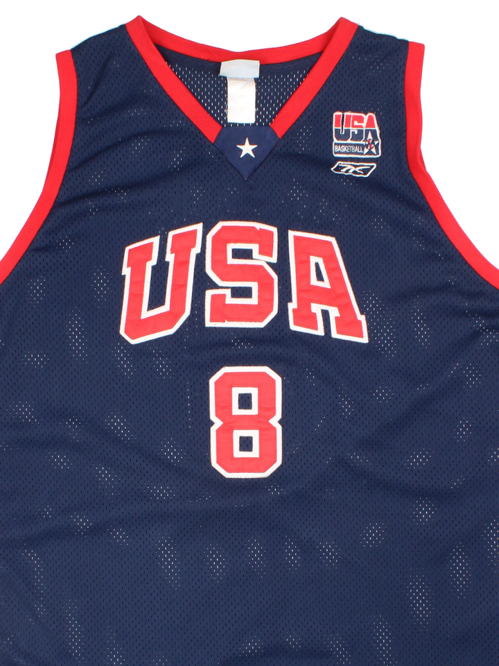 Vintage USA Dream Team Kobe Bryant Nike Basketball Jersey in a navy blue kit colourway, features embroidered logos and badge on the front, and on the back Bryant number 8.