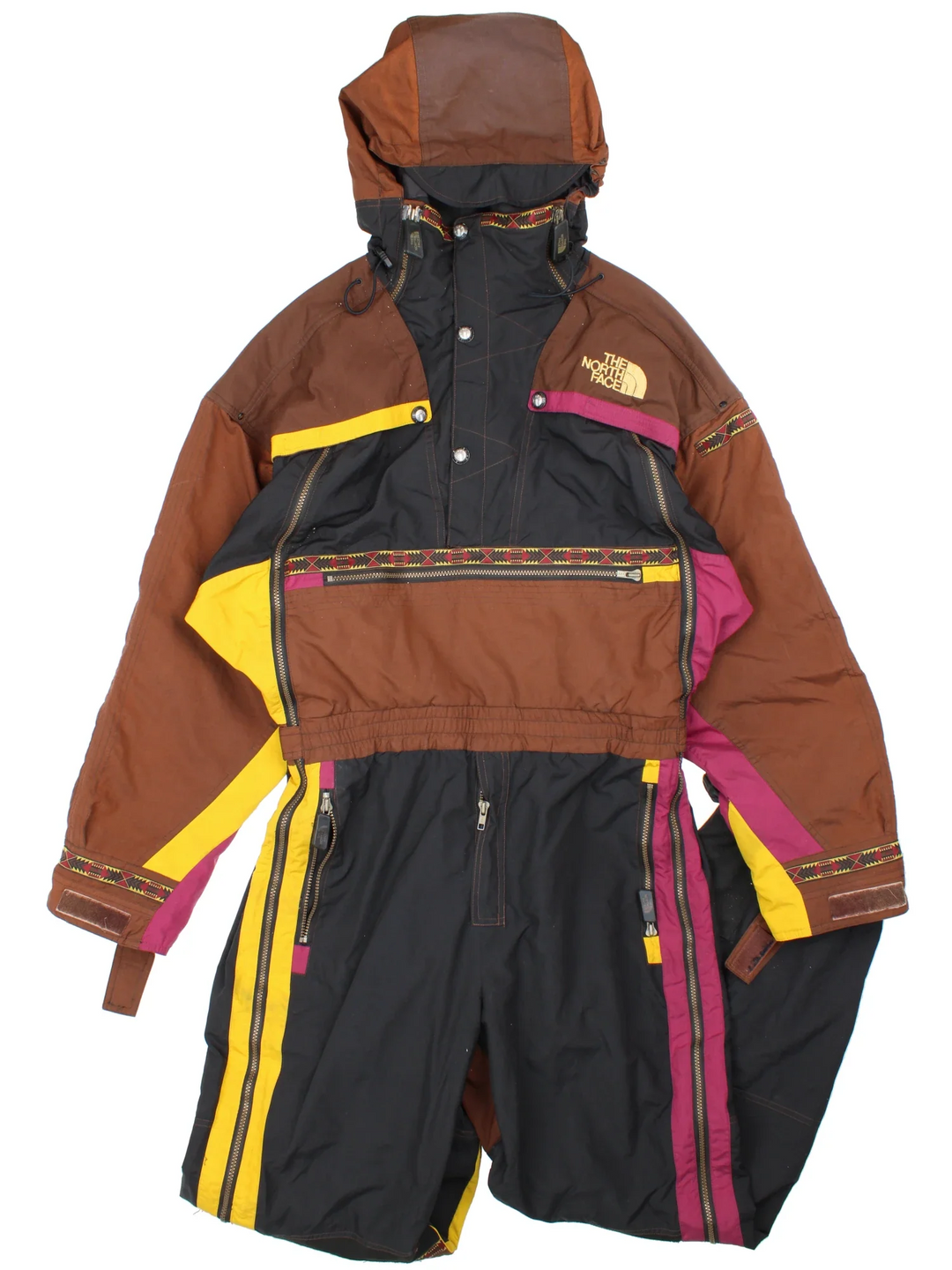 The North Face TNF Rage Series Ski Suit  in black/brown colourway with multiple pockets, some slight padding, elasticated waistband. Embroidered branding on the front and back.