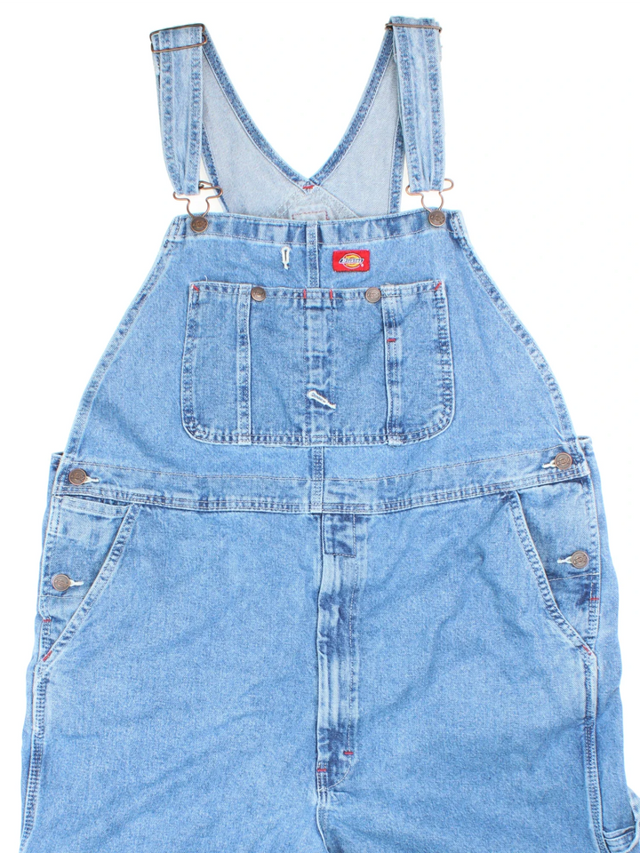 Dickies Dungarees in blue colourway with multiple pockets, adjustable straps and the logo embroidered on the front.