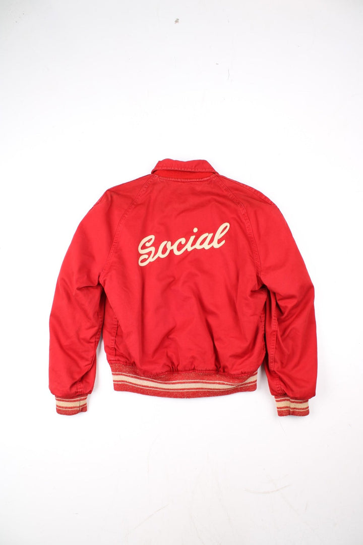 Vintage 70's Reversible Varsity Jacket in a red colourway with either canvas or woolen reversible options. Zips up and has side pockets, and has 'American Turner Social' logo embroidered on the front and back.