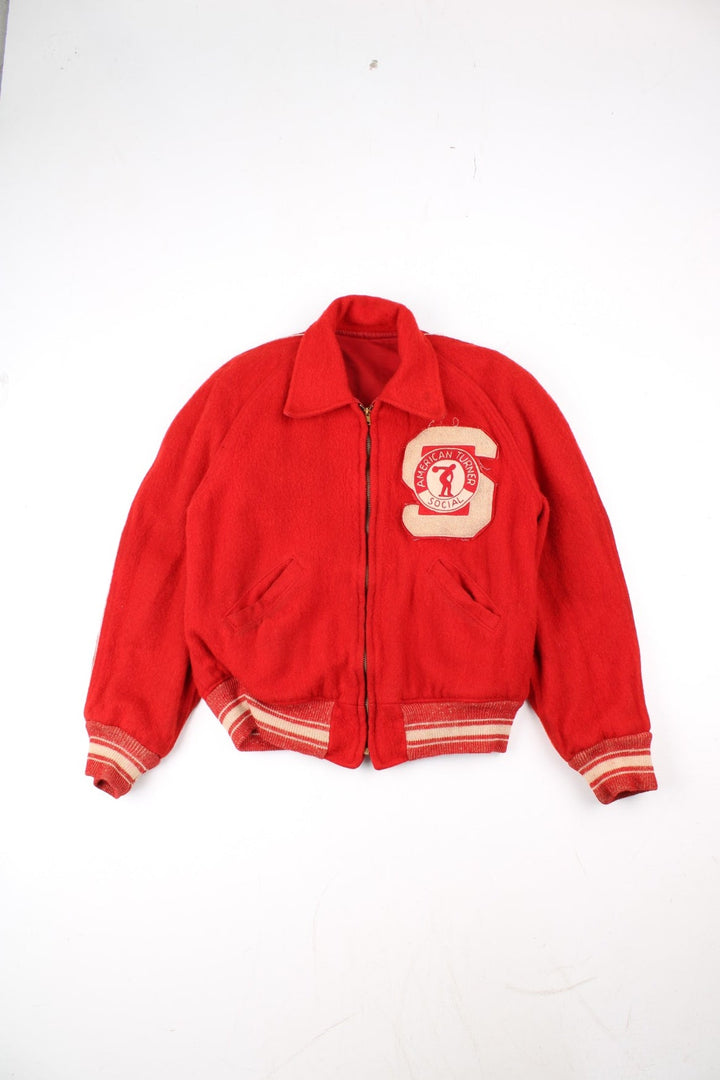 Vintage 70's Reversible Varsity Jacket in a red colourway with either canvas or woolen reversible options. Zips up and has side pockets, and has 'American Turner Social' logo embroidered on the front and back.