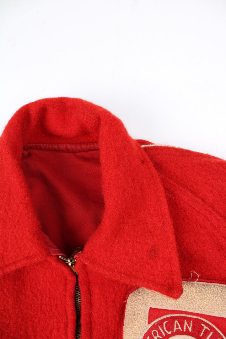Vintage 70's Reversible Varsity Jacket in a red colourway with either canvas or woolen reversible options. Zips up and has side pockets, and has 'American Turner Social' logo embroidered on the front and back.