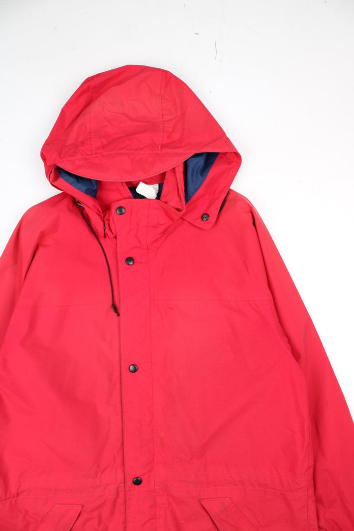 Vintage Mountain Equipment Jacket in a red colourway. Zips up and has side pockets, hooded, and has the logo embroidered on the front by the hem.
