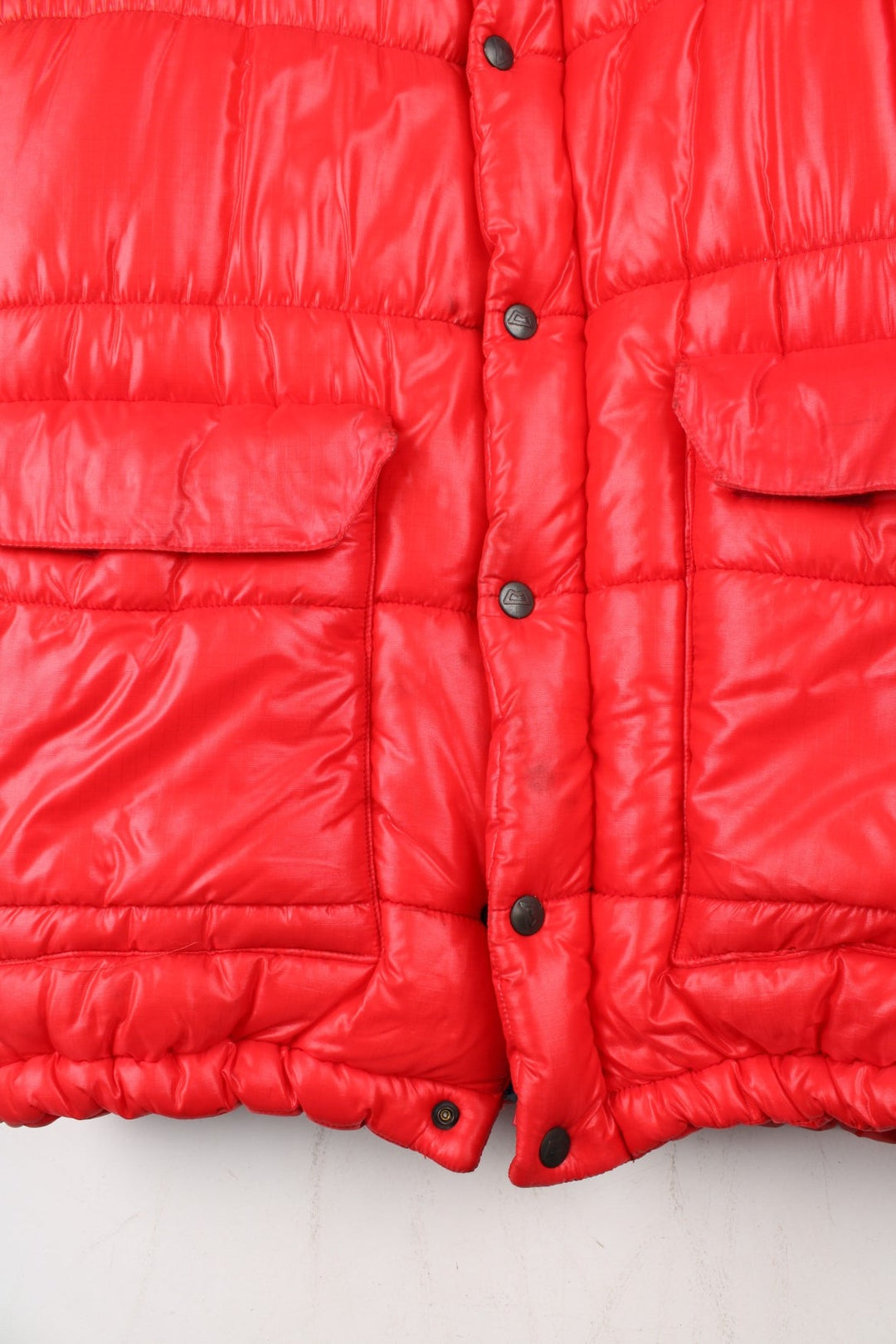Vintage 80's Mountain Equipment Cerro Torre Puffer Coat in a red colourway. Zips and buttons up, has double front pockets, insulated lining, detachable hood, and has the logo embroidered on the front.