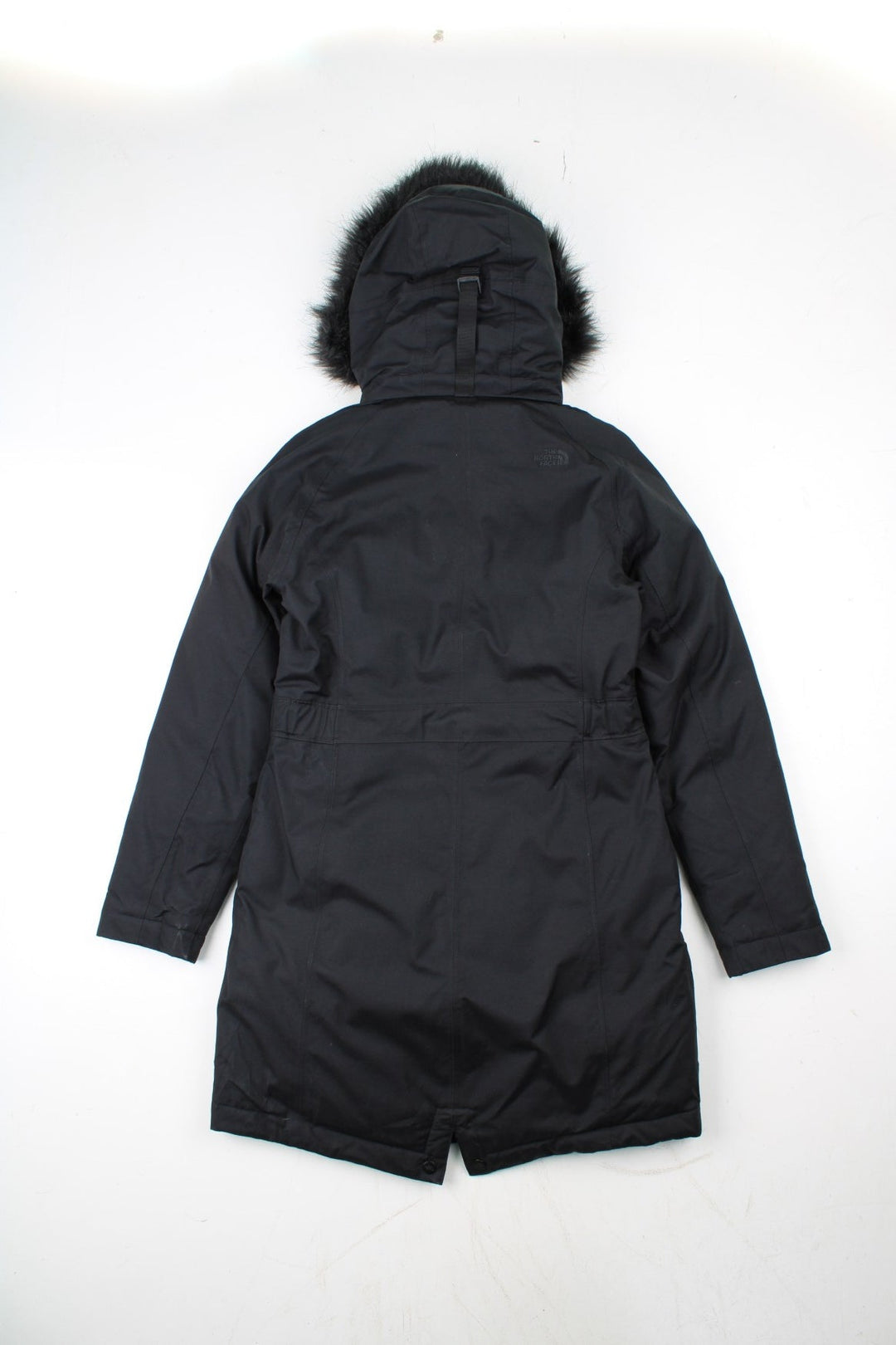 The North Face Jacket in a black colourway. Zips up and has side pockets, insulated lining, hooded with a faux fur trim, and has the logos embroidered on the left sleeve.