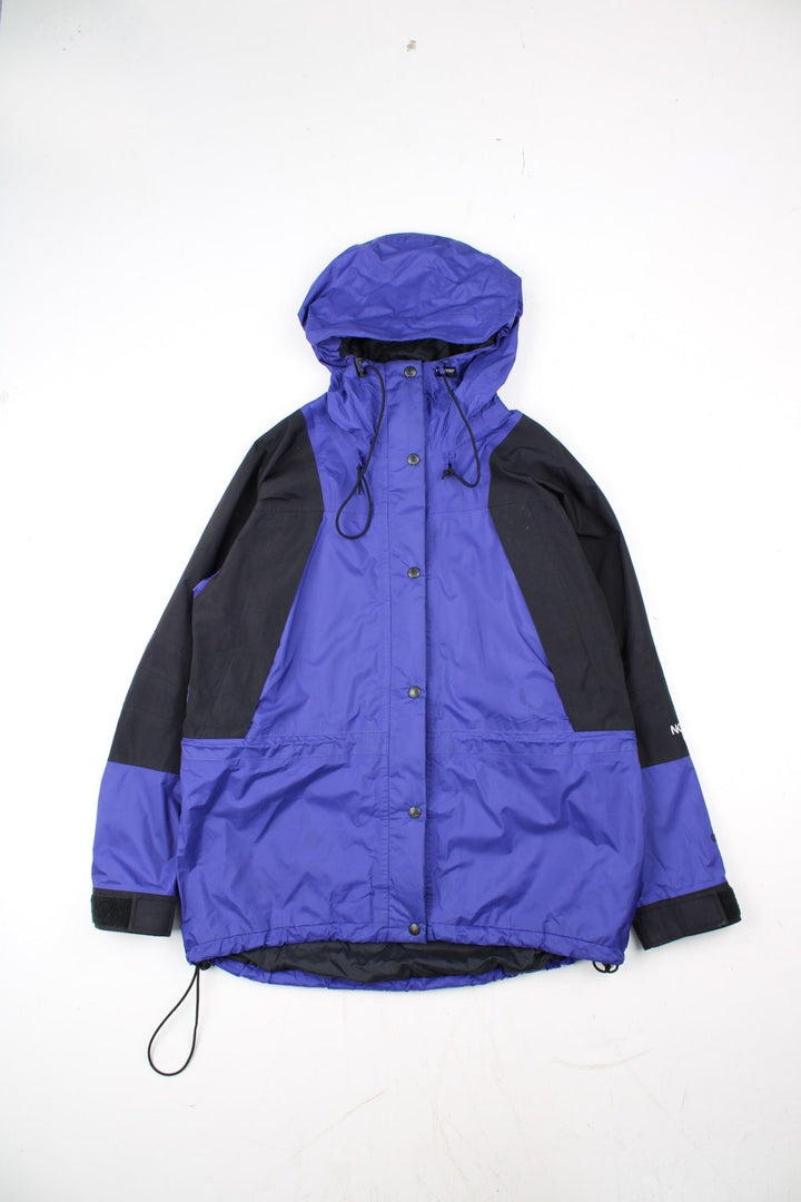 Vintage The North Face Mountain Light Jacket in a purple and black colourway. Zips and buttons up, has side pockets, hooded, and has the logo embroidered on the left sleeve.